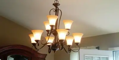 Classic ceiling chandelier installation with warm lighting in Tacoma, WA