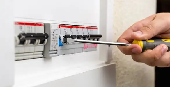 electrical panel upgrade service showing technician adjusting circuit breakers during system upgrade in Tacoma, WA