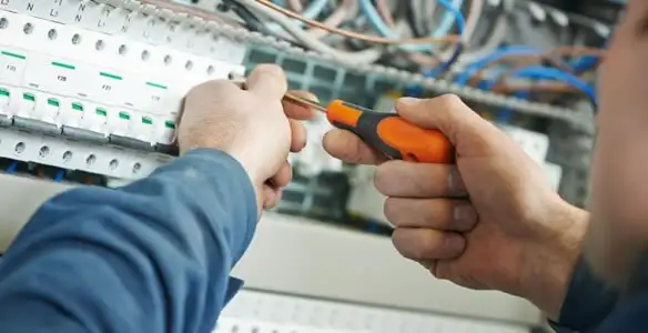 electrical service showing licensed electrician performing electrical panel maintenance and adjustments in Tacoma, WA