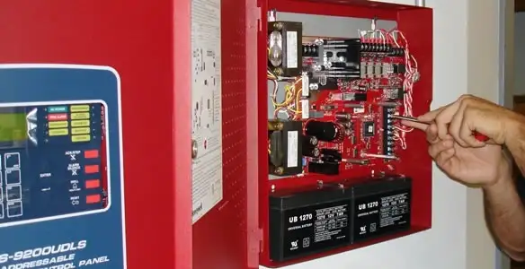 fire alarm installation service showing technician configuring fire alarm control panel in Tacoma, WA