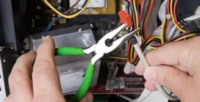 Licensed electrical contractor performing electrical repair with tools in Federal Way, WA