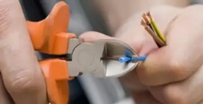 professional electrical services showing precise wire cutting by licensed electricians in Tacoma, WA