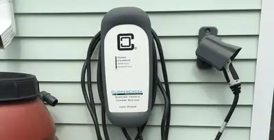 Outdoor electric vehicle charger installation on residential wall in Tacoma, WA