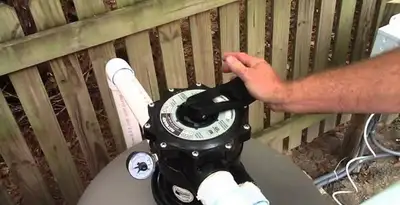 pool pumps service showing professional adjustment of pool pump control system in Tacoma, WA